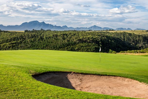 Oubaai Golf Estate View Of Putting Green With Gorge And Mountain In The Background